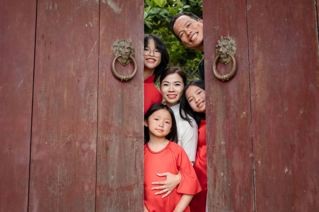 Một người mẹ (hoặc cha) người Việt cao niên vui vẻ bên con đã trưởng thành — quyền lợi bảo hiểm được trả miễn thuế cho người thụ hưởng